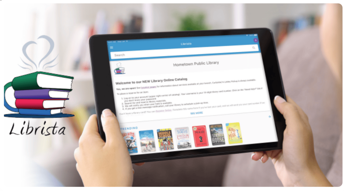 A person holds a tablet displaying the Hometown Public Library online catalog. The screen shows trending books. On the left, there is a Librista logo with a stack of books and steam rising above them.